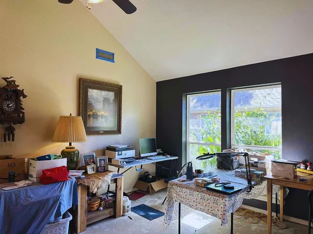a living room with lots of furniture and a large window