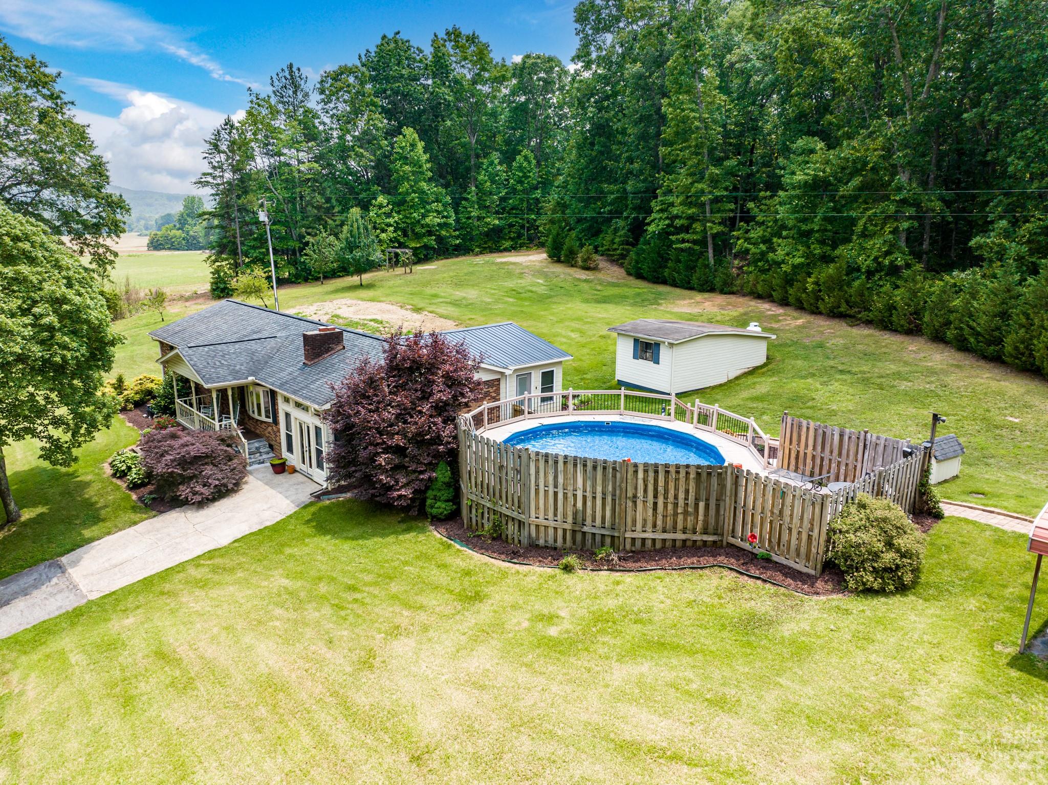 151 Elm Road Blacksburg, SC 29702 - Photo 7 of 35 a view of a swimming pool with a garden and deck