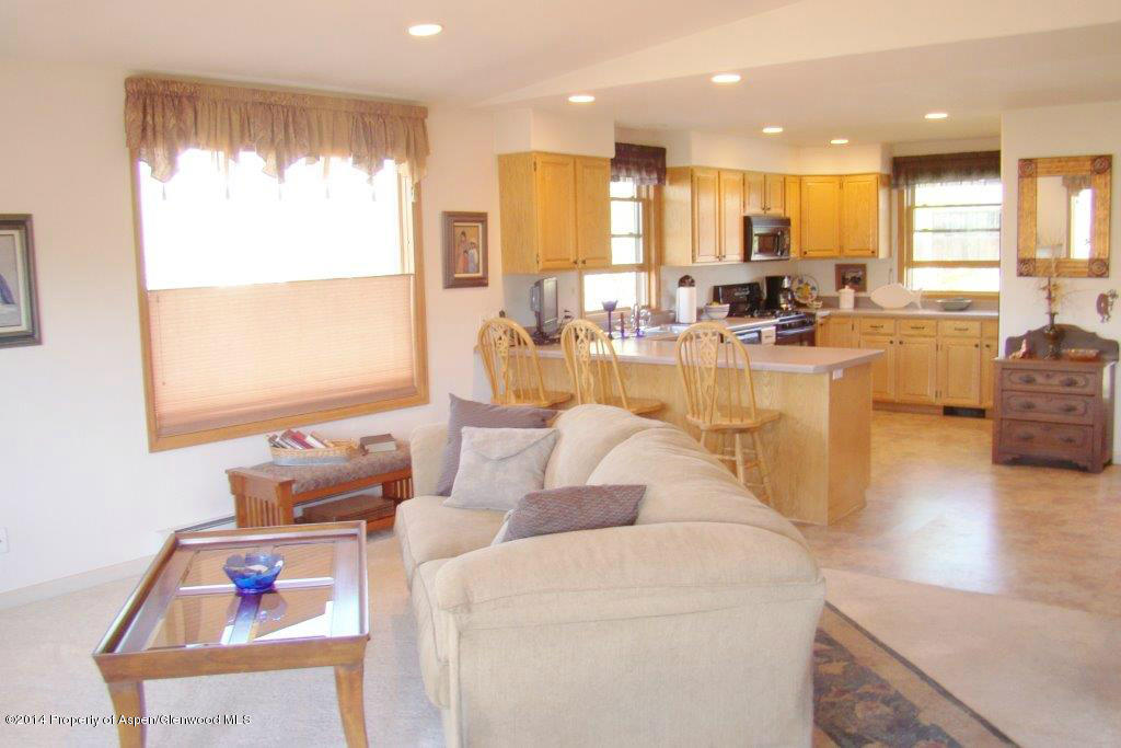 1001 Arnold Court Rifle, CO 81650 - Photo 14 of 39 a view of kitchen with dining table wooden floor and a large window