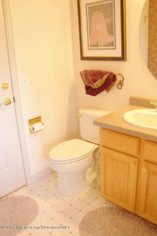 1001 Arnold Court Rifle, CO 81650 - Photo 17 of 39 a white toilet sitting next to a bathroom sink