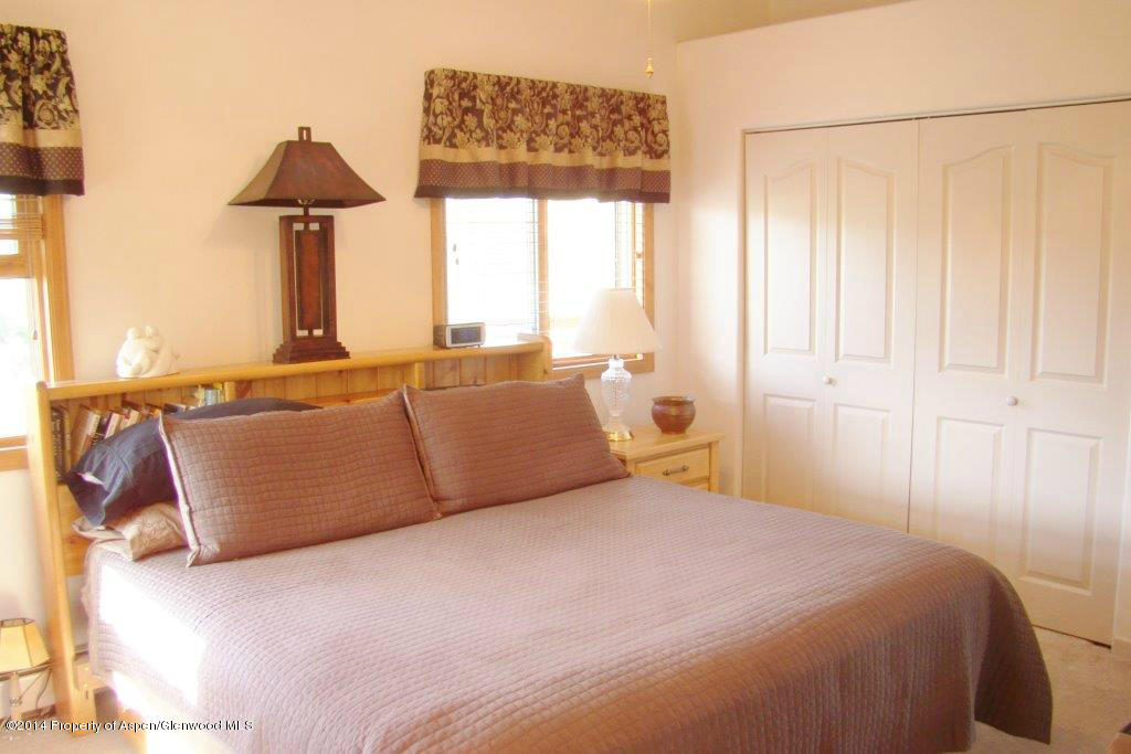 1001 Arnold Court Rifle, CO 81650 - Photo 19 of 39 a bedroom with a large bed and a window