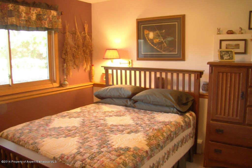 1001 Arnold Court Rifle, CO 81650 - Photo 25 of 39 a bed sitting in a bedroom next to a window