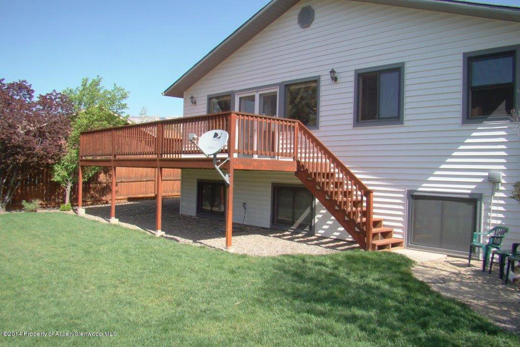1001 Arnold Court Rifle, CO 81650 - Photo 31 of 39 a view of a house with a yard and a wooden deck