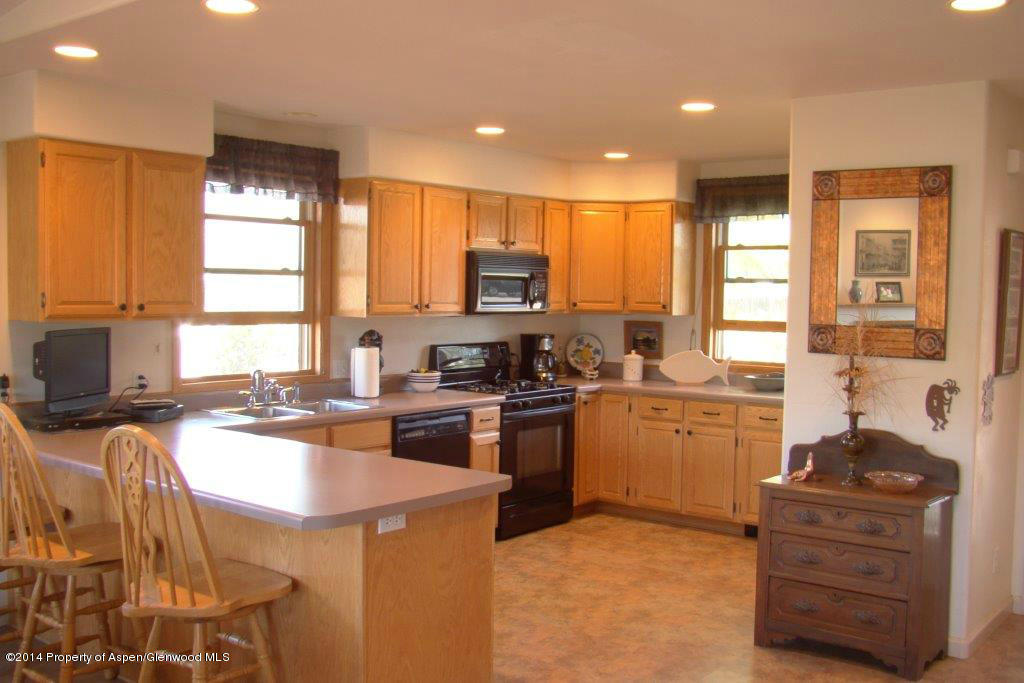 1001 Arnold Court Rifle, CO 81650 - Photo 8 of 39 a kitchen with a sink stove top oven and refrigerator
