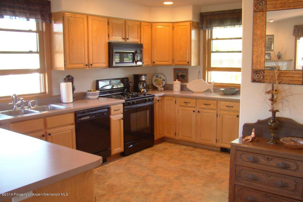1001 Arnold Court Rifle, CO 81650 - Photo 9 of 39 a kitchen with stainless steel appliances granite countertop a stove a sink and a microwave