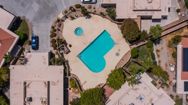 an aerial view of a house with swimming pool and outdoor space