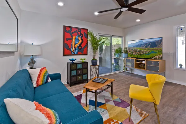 a living room with furniture and wooden floor