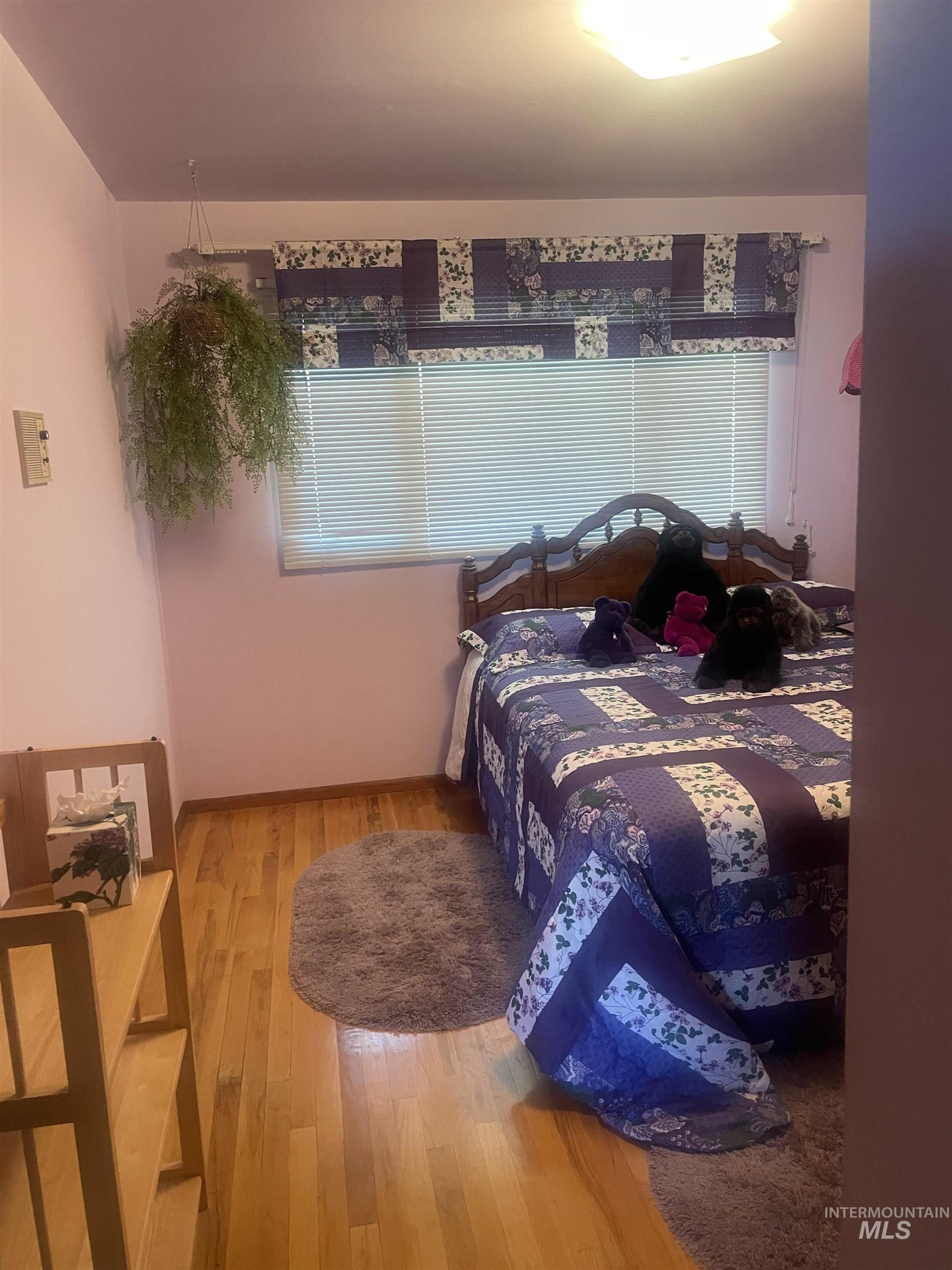 2002 Missman Road Council, ID 83612 - Photo 20 of 38 Bedroom featuring wood finished floors and baseboards