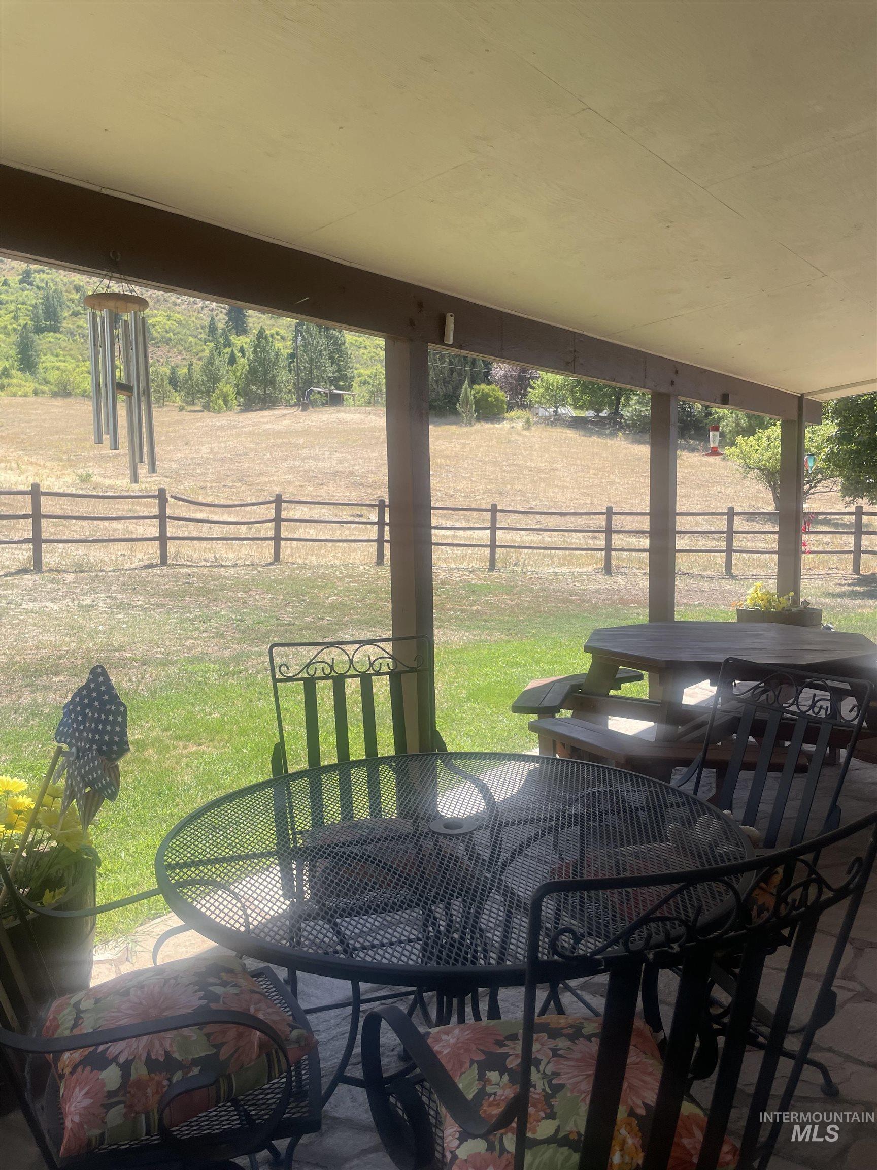 2002 Missman Road Council, ID 83612 - Photo 31 of 38 Fenced backyard with outdoor dining space and a patio