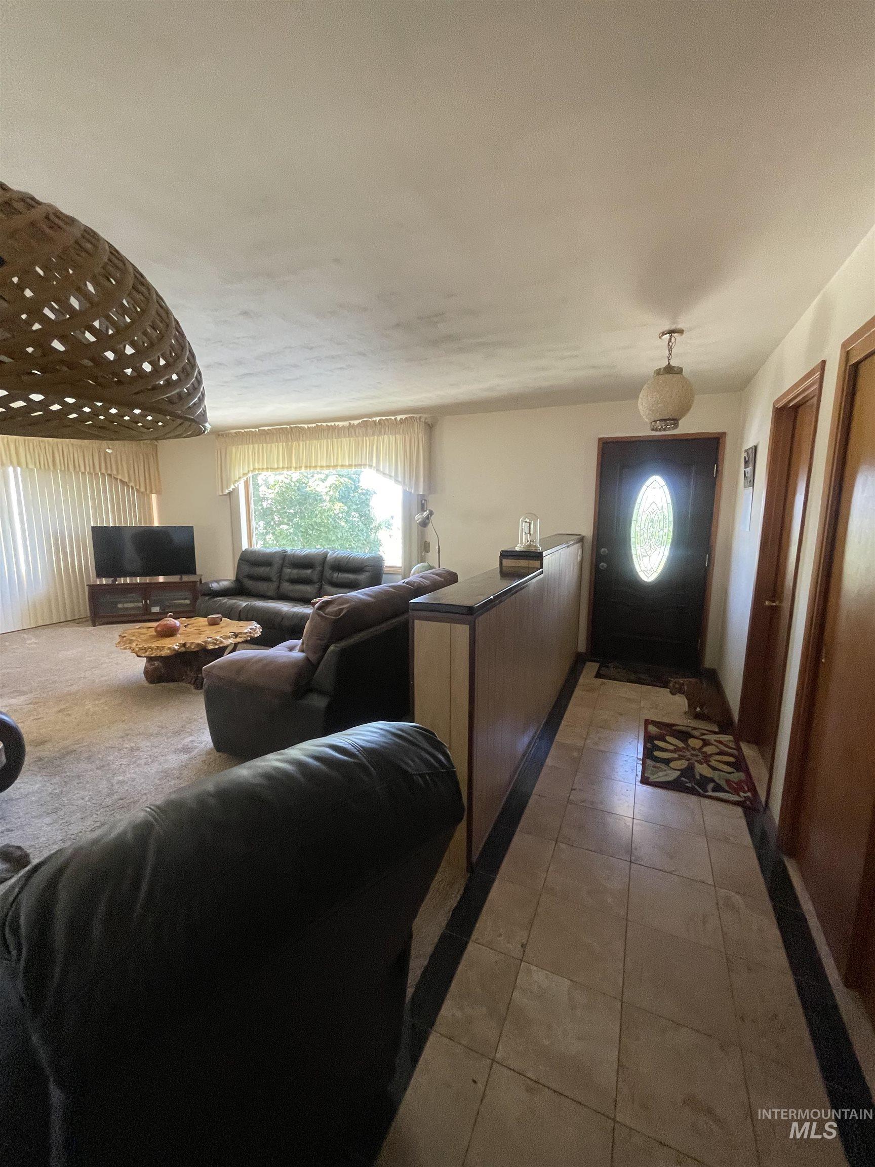 2002 Missman Road Council, ID 83612 - Photo 10 of 38 Living area featuring light tile patterned floors