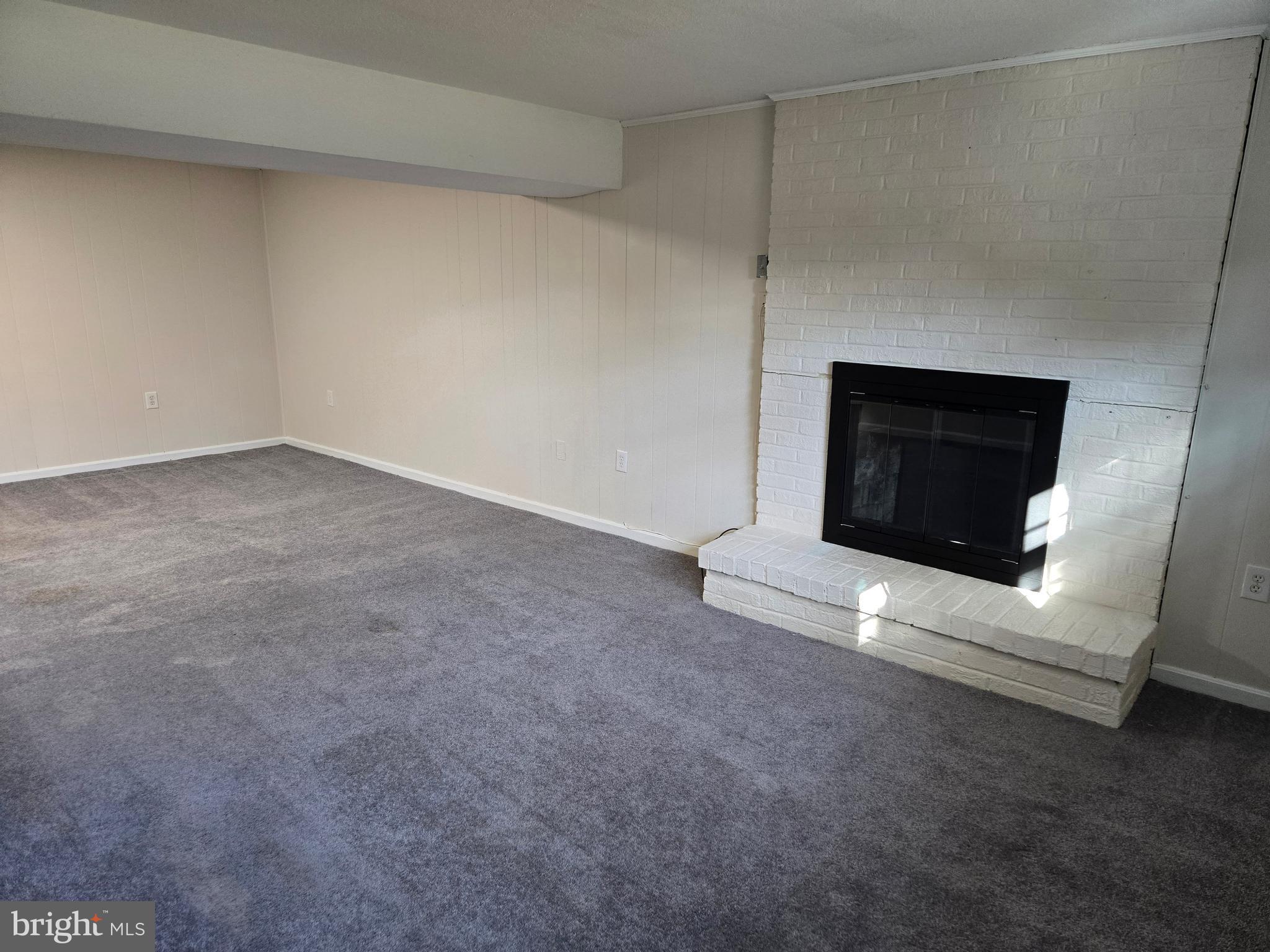 341 South 26th Street, Unit A Purcellville, VA 20132 - Photo 30 of 33 a view of an empty room with a fireplace and a window