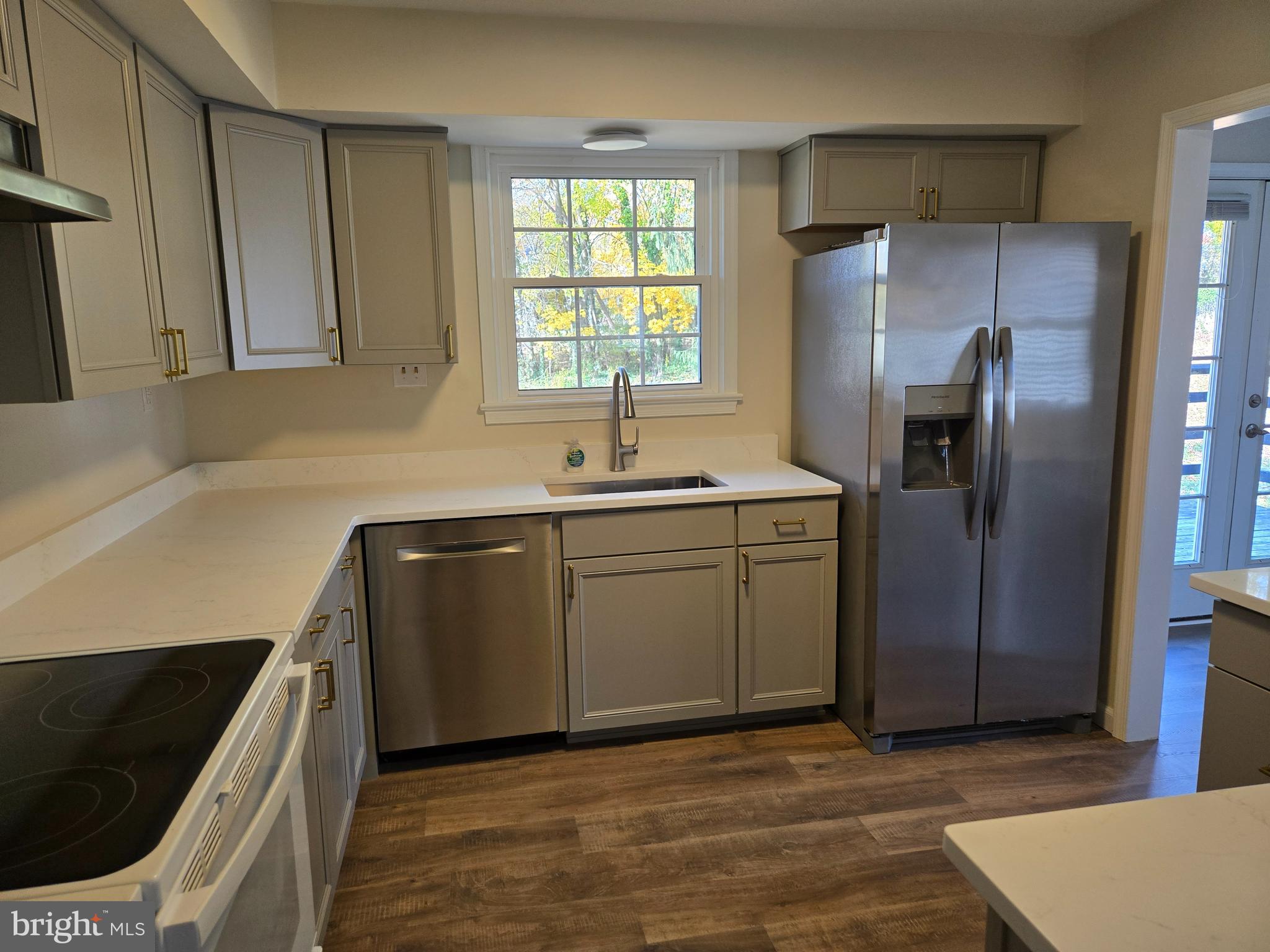 341 South 26th Street, Unit A Purcellville, VA 20132 - Photo 9 of 33 a kitchen with stainless steel appliances granite countertop a sink a refrigerator and a stove