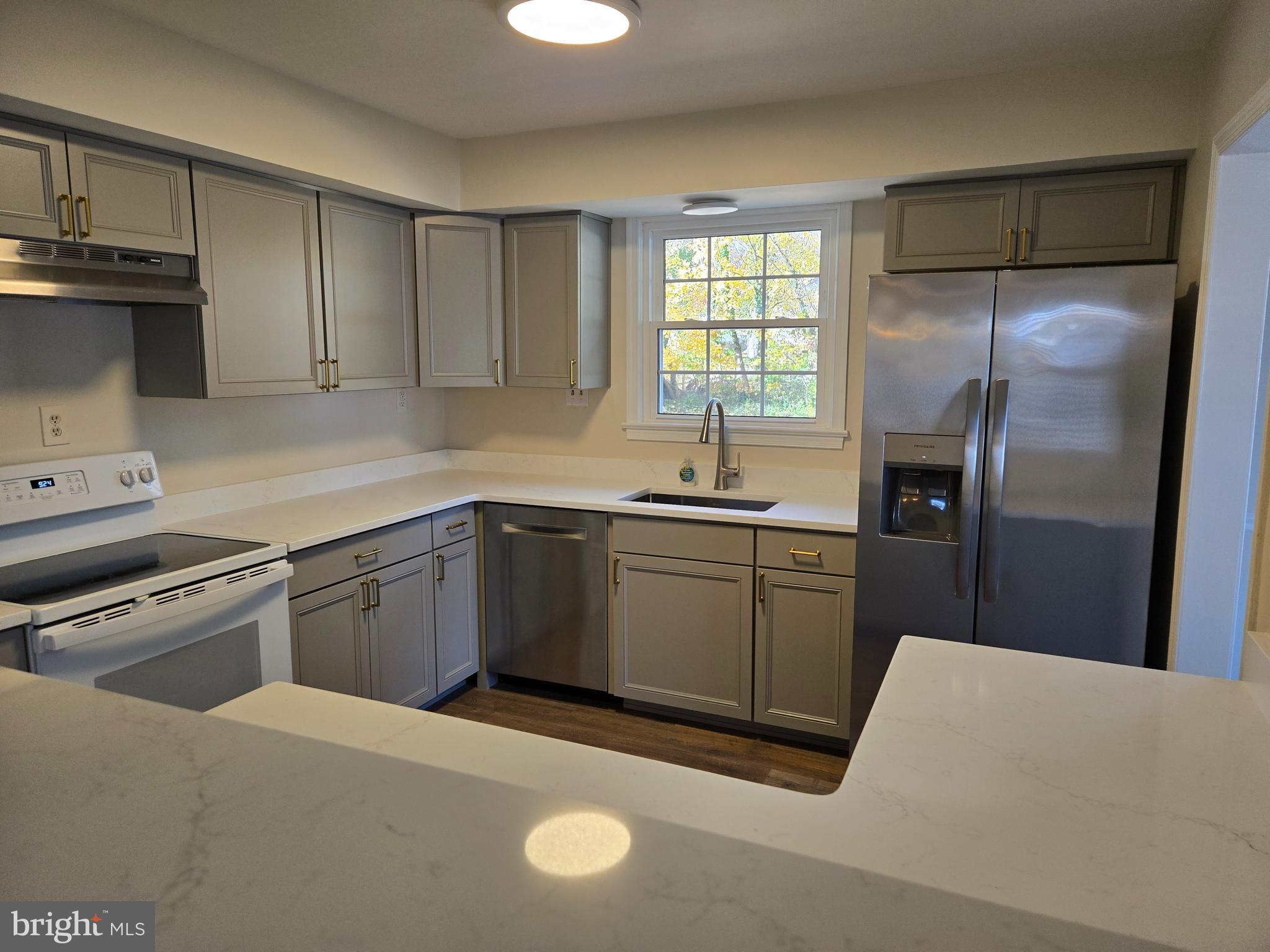 341 South 26th Street, Unit A Purcellville, VA 20132 - Photo 10 of 33 a kitchen with a sink a stove a refrigerator and cabinets