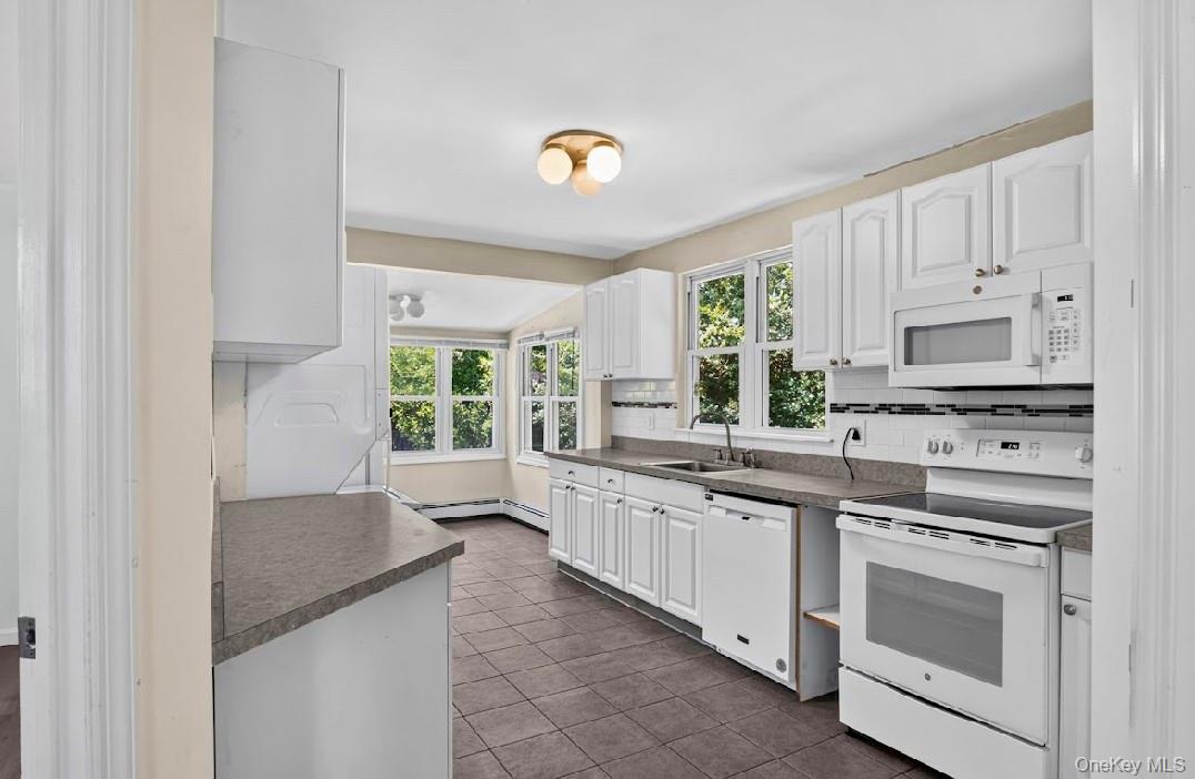62 Shell Road Rocky Point, NY 11778 - Photo 4 of 22 Kitchen featuring stove, microwave, dishwasher.