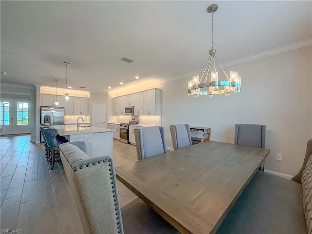 a large kitchen with stainless steel appliances granite countertop a lot of counter space and wooden floors