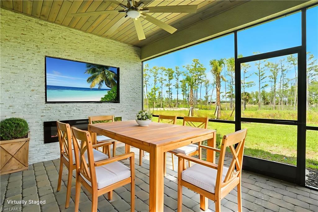 20489 Verawood Loop Estero, FL 33928 - Photo 16 of 50 Sunroom with outdoor dining space, a ceiling fan, and healthy amount of natural light