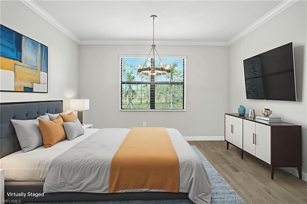 20489 Verawood Loop Estero, FL 33928 - Photo 17 of 50 Bedroom with ornamental molding, wood finished floors, and a chandelier