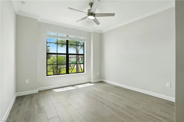a view of an empty room with wooden floor