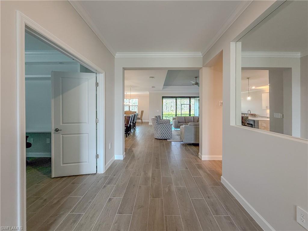20489 Verawood Loop Estero, FL 33928 - Photo 2 of 50 Hall with wood finish floors and crown molding