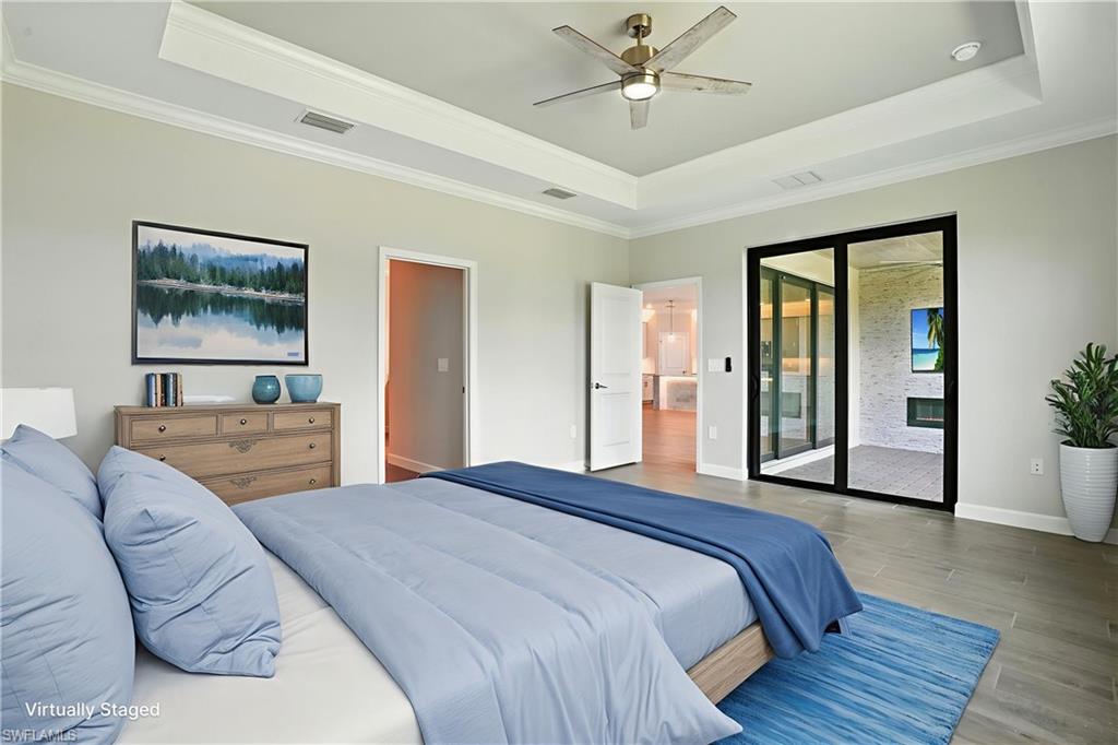 20489 Verawood Loop Estero, FL 33928 - Photo 28 of 50 Bedroom with a raised ceiling, wood finished floors, ornamental molding, access to exterior, and ceiling fan