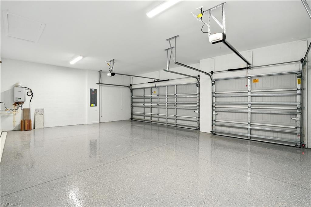 20489 Verawood Loop Estero, FL 33928 - Photo 37 of 50 Garage with electric panel and a garage door opener