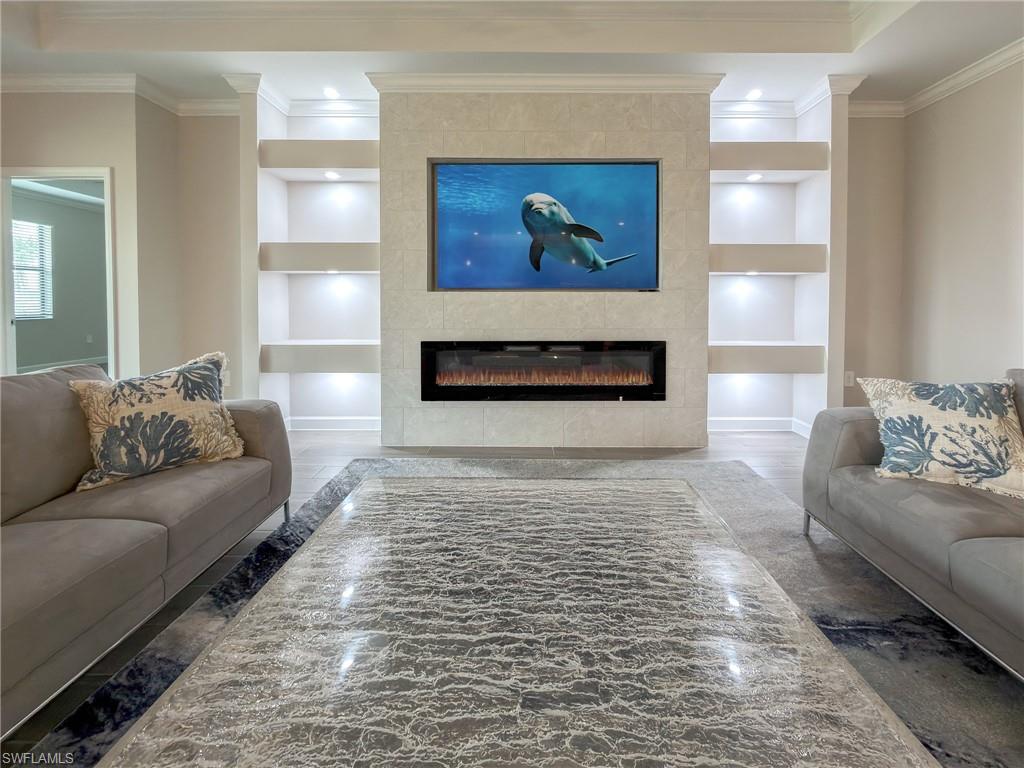 20489 Verawood Loop Estero, FL 33928 - Photo 7 of 50 Living area featuring built in features, a fireplace, ornamental molding, wood finished floors, and recessed lighting