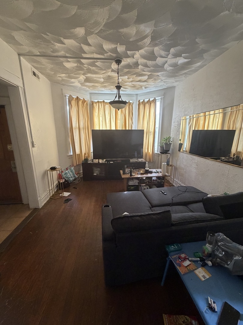 7316 South Lowe Avenue Chicago, IL 60621 - Photo 16 of 16 a living room with furniture and a flat screen tv