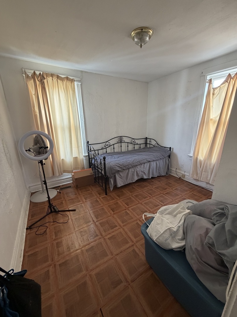 7316 South Lowe Avenue Chicago, IL 60621 - Photo 6 of 16 a bedroom with a bed and a window