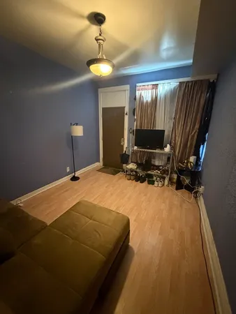 a living room with furniture and a ceiling fan
