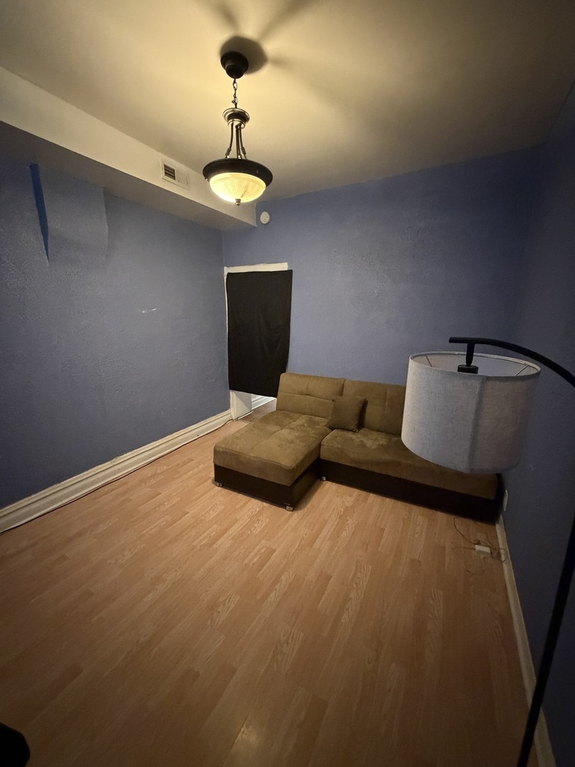 7316 South Lowe Avenue Chicago, IL 60621 - Photo 8 of 16 a living room with furniture and a ceiling fan