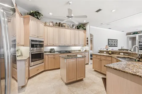 a kitchen with stainless steel appliances granite countertop a stove oven and a refrigerator