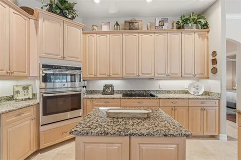 a kitchen with sink stove and cabinets