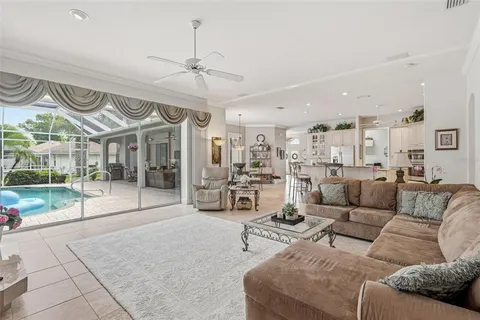 a bedroom with a bed a window and a flat screen television