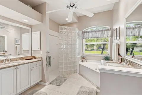 a bathroom with a tub sink and mirror