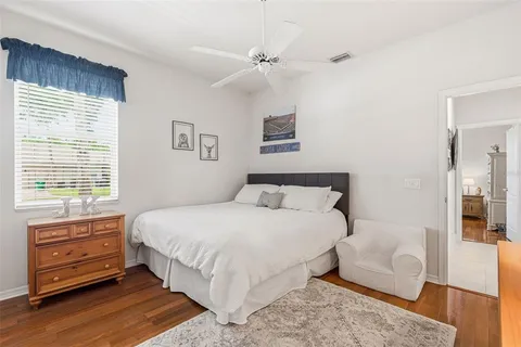 a bedroom with a large bed and a chandelier