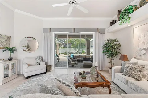 a living room with furniture a window and a chandelier