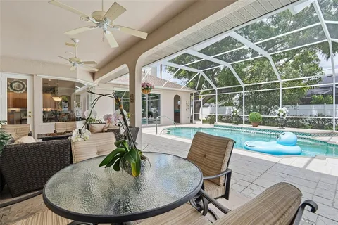 an aerial view of a house with yard swimming pool and outdoor seating