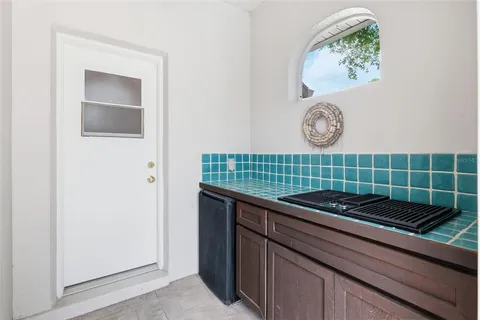 an aerial view of residential houses with outdoor space and trees