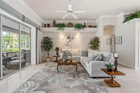 a living room with furniture a clock on wall and a table