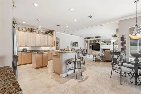 a kitchen with stainless steel appliances granite countertop a stove oven and a refrigerator
