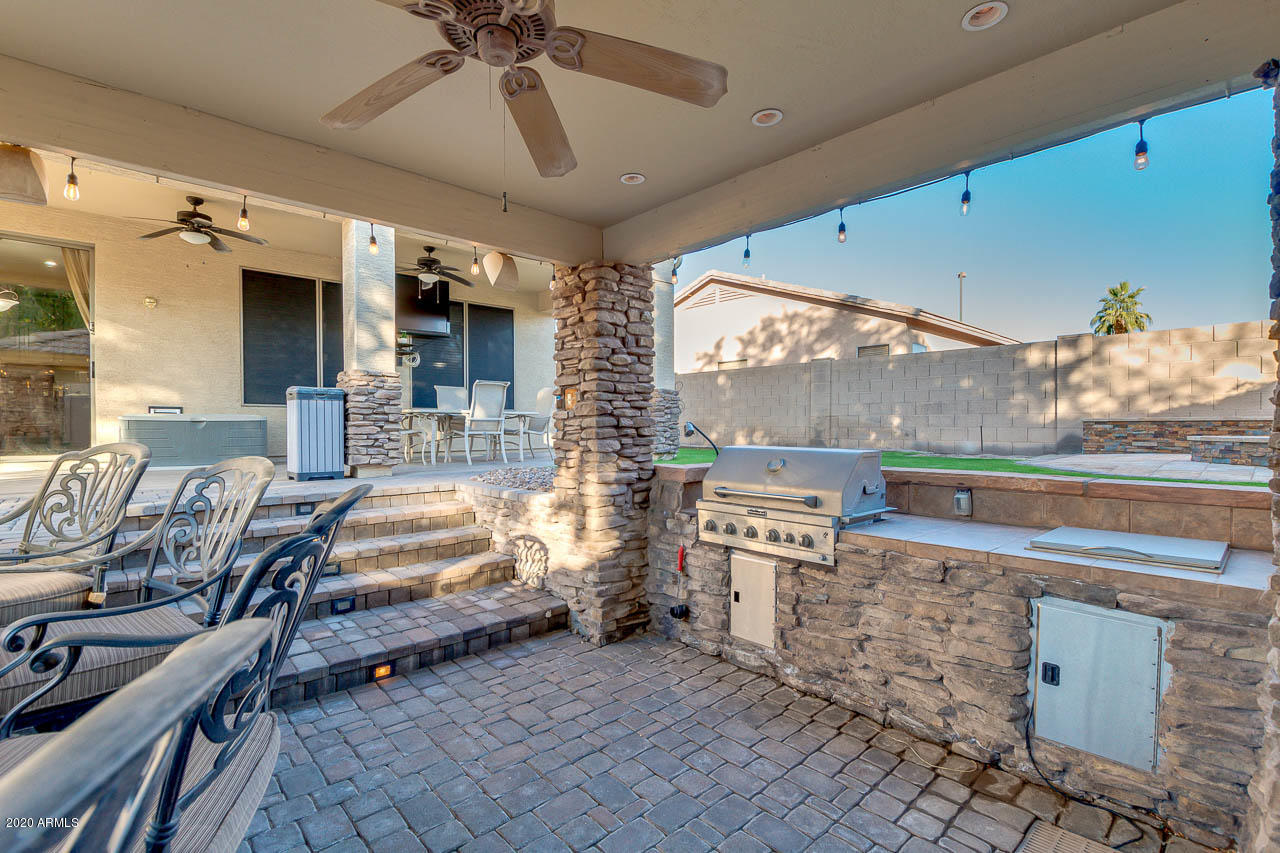 3315 East Los Altos Road Gilbert, AZ 85297 - Photo 57 of 66 a room with furniture a flat screen tv and a floor to ceiling window