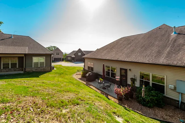 a view of a house with swimming pool and a yard