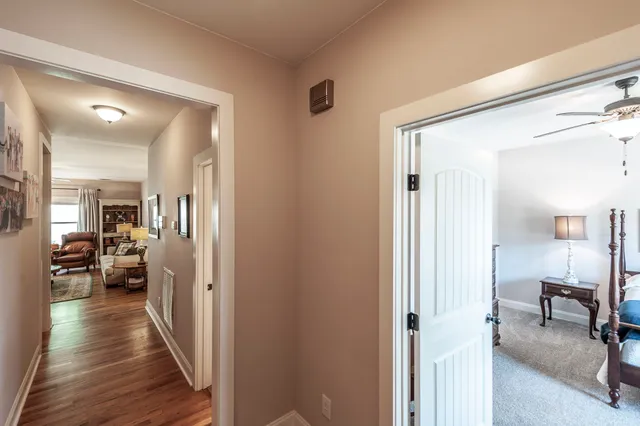 a view of a hallway with a livingroom and furniture
