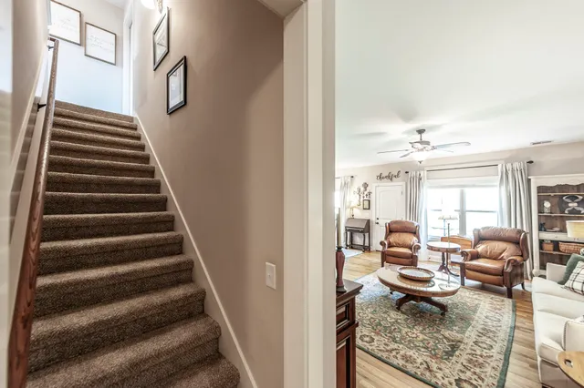 a living room with furniture and a chandelier