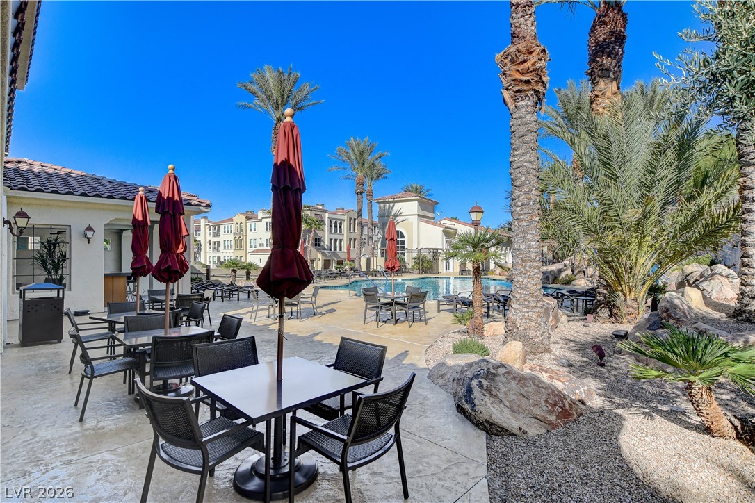 2555 Hampton Road, Unit 2207 Henderson, NV 89052 - Photo 55 of 74 A tranquil courtyard features multiple outdoor seating areas and a sparkling community pool, perfect for relaxation.
