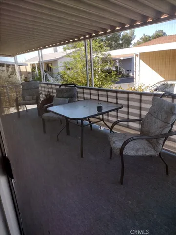 a view of a outdoor kitchen with a table and chairs