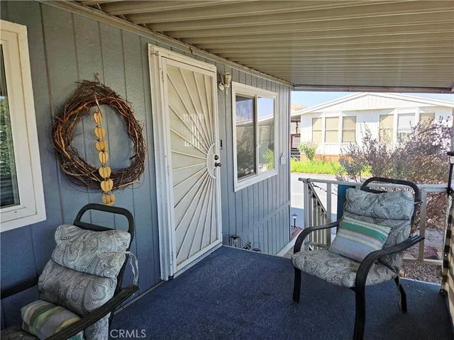 a view of a livingroom with furniture and a large window