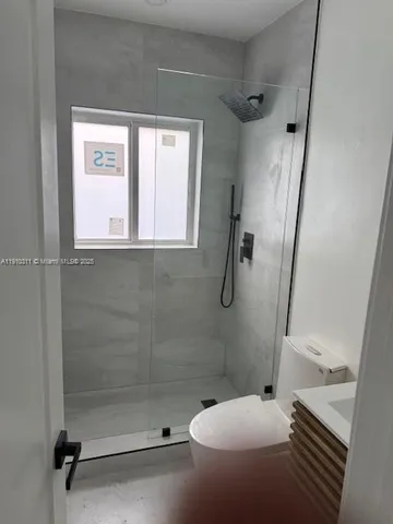 a bathroom with a toilet and a shower