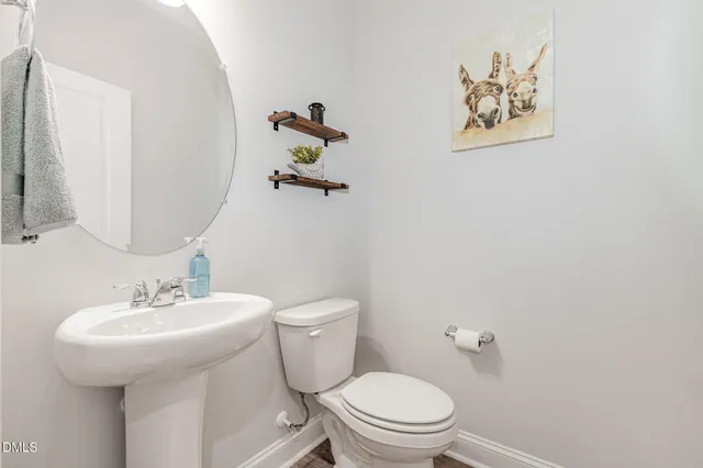 a white toilet sitting next to a bathroom sink