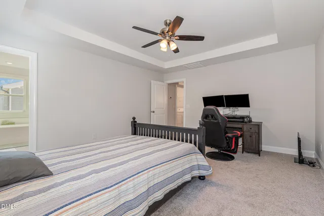 a bedroom with a bed and a television